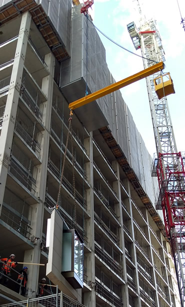 Counter Balance Lifting Beam designed to lift wall panels shown positioning a unit under a scaffold overhang.