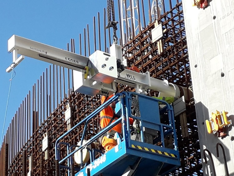 Bespoke 800kg electric counter balance lifting beam fitting conduits into a wall at Hinckley Point Nuclear Power Station